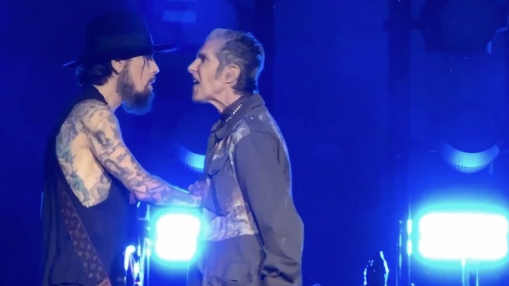 Two men handshaking on concert stage