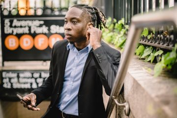 Man in suit looking at phone.