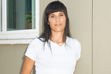 Female in white shirt smiling.