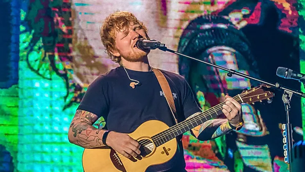 Ed Sheeran singing on concert stage