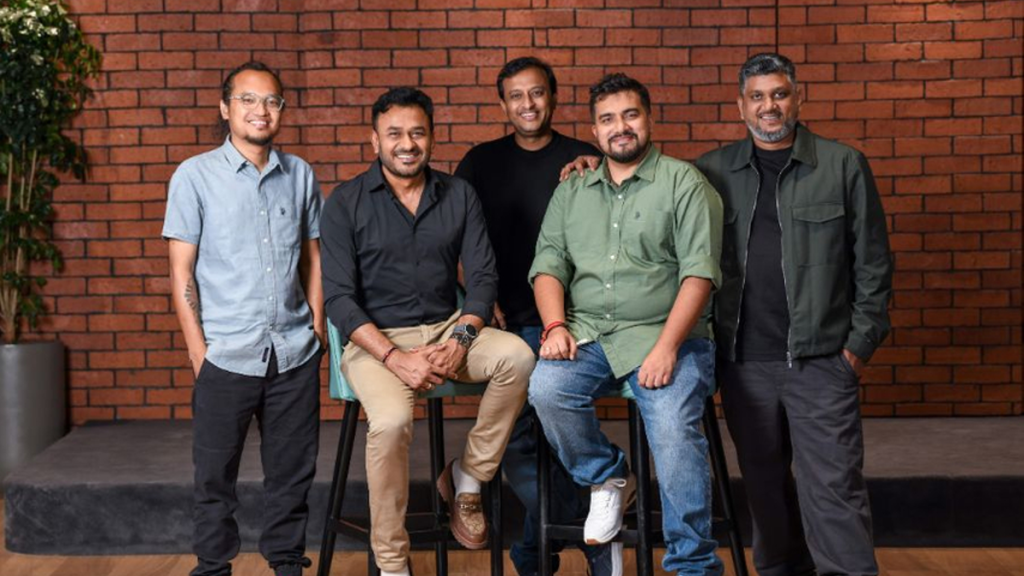 Men standing against brick wall