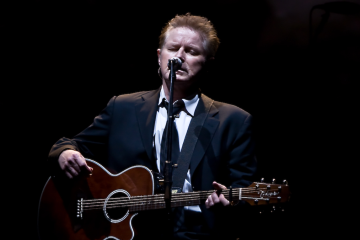 Don Henley performing with guitar onstage