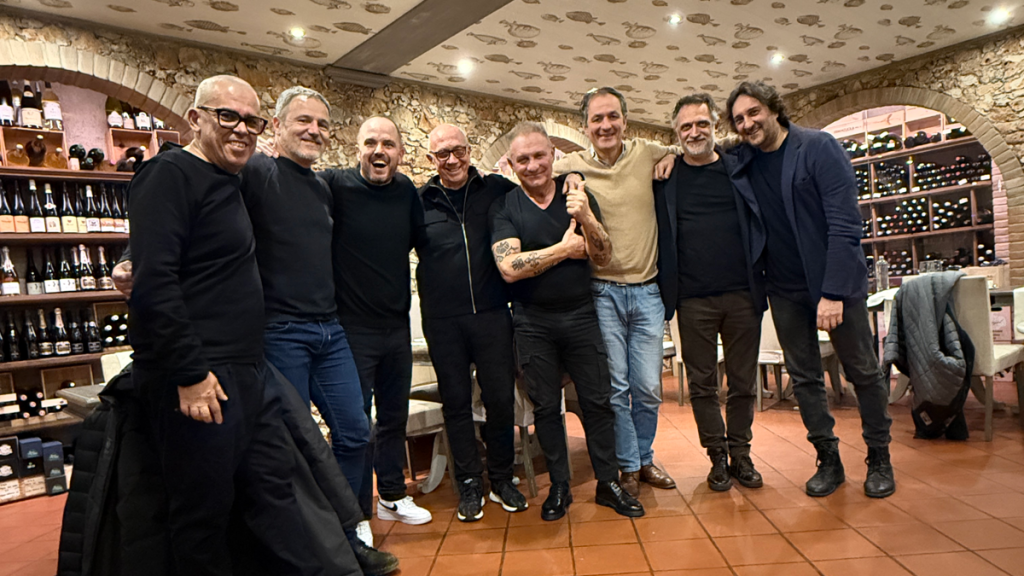 Men gather in wine storage room