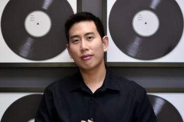 Man holding vinyl records in store