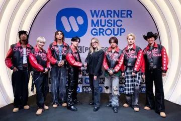 Group posing at Warner Music signing